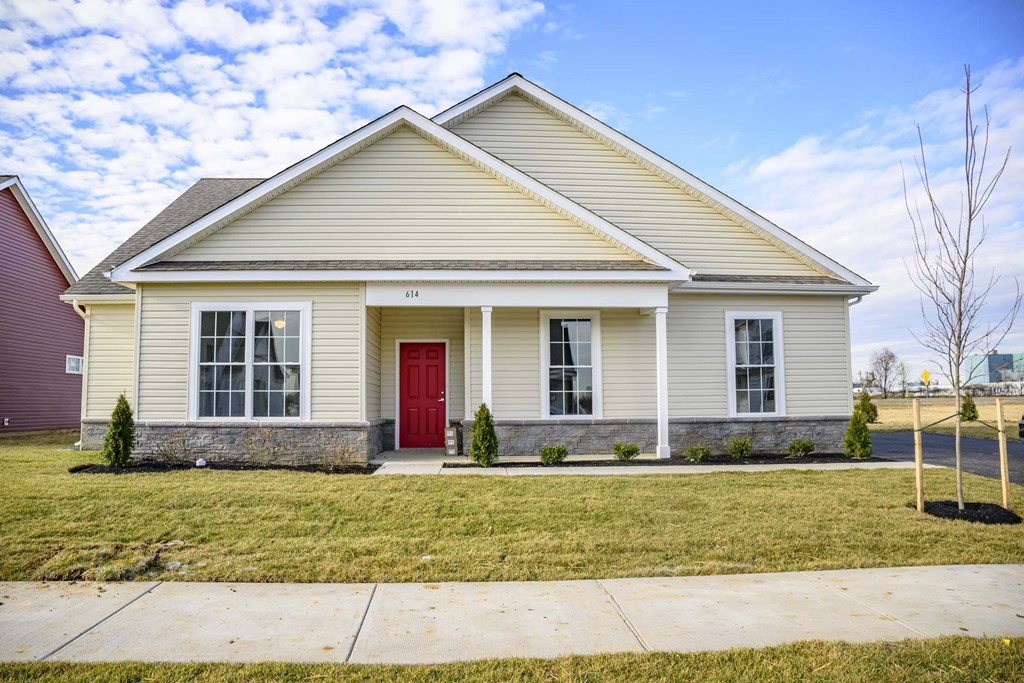 Exterior of pale yellow single story cottage