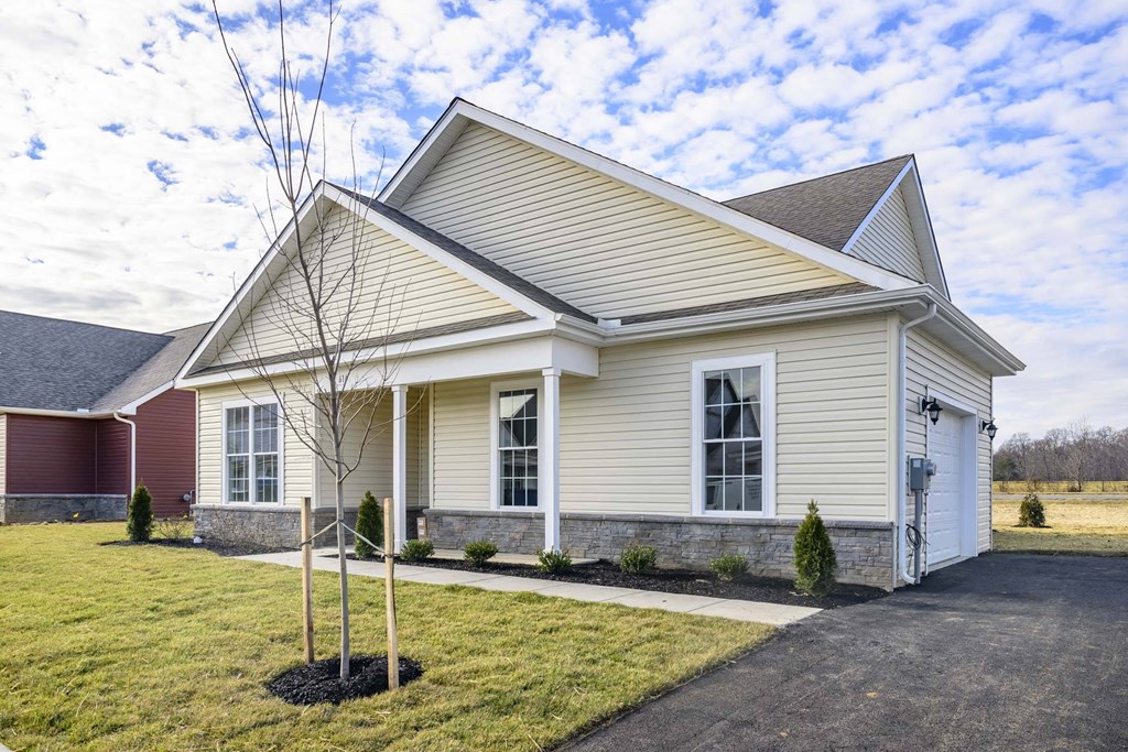 Exterior of pale yellow single story cottage
