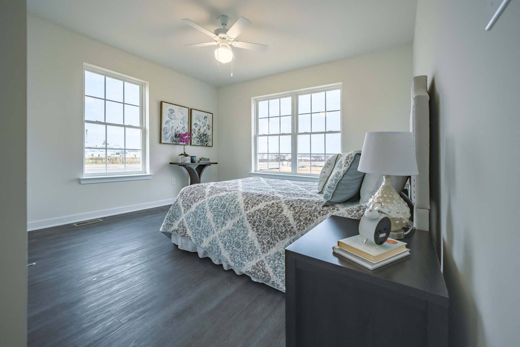 2nd bedroom with windows and fan