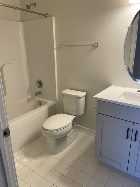 a bathroom with a toilet and a tub and a sink