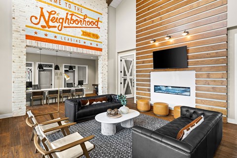 a living room with two leather couches and a white coffee table