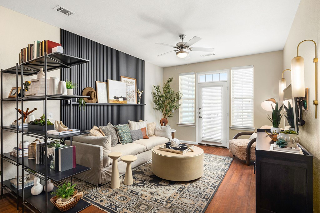 a living room with a white couch and a ceiling fan