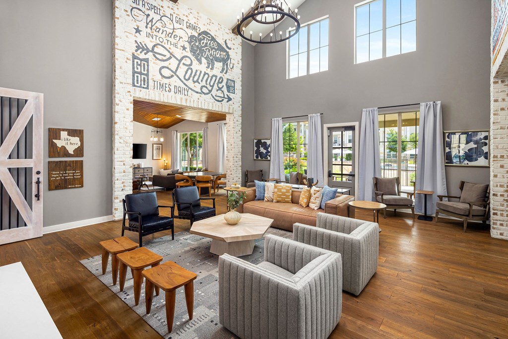 a living room with a couch and chairs and a table