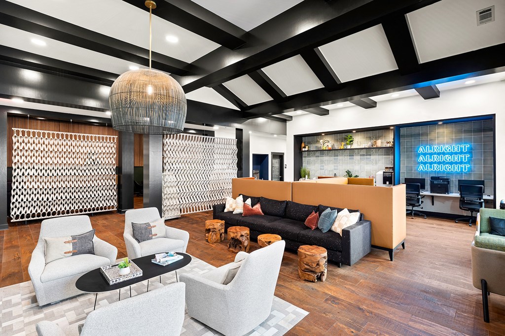 a living room with couches and chairs and a lobby area with a lobby sign