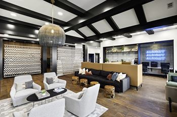 a lobby with couches and chairs and a reception area
