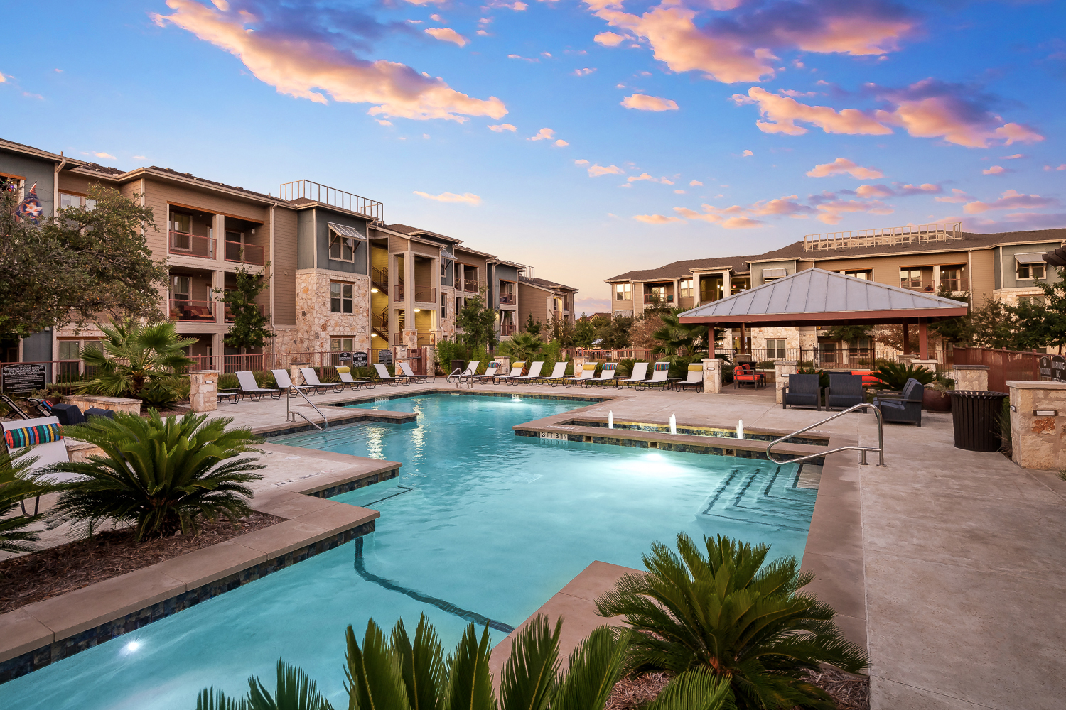 a large swimming pool with buildings in the background