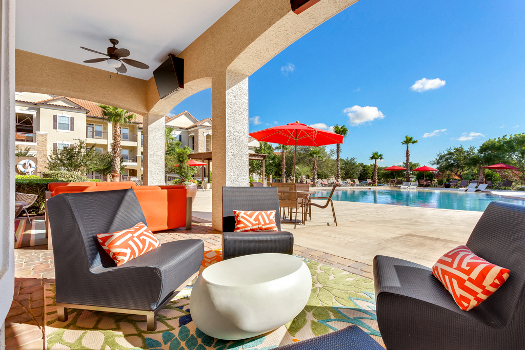 a patio with chairs and a swimming pool