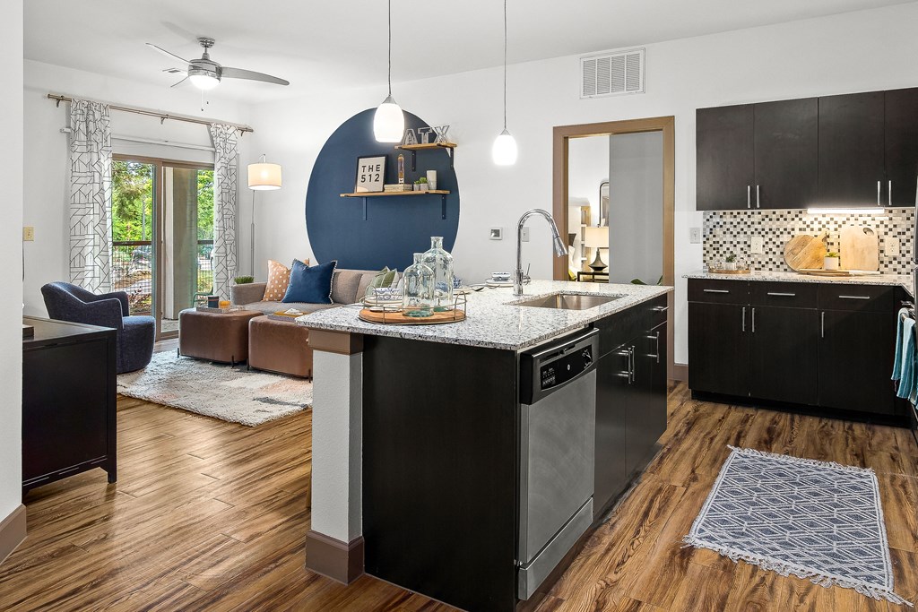 an open kitchen and living room with a blue accent wall