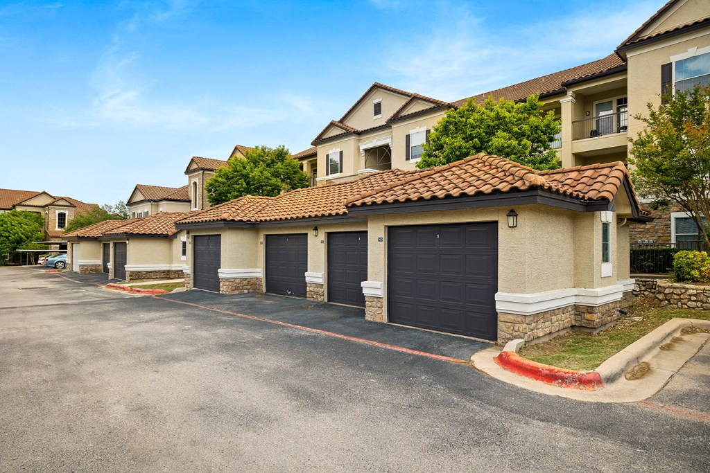 a row of houses with garages in front of them