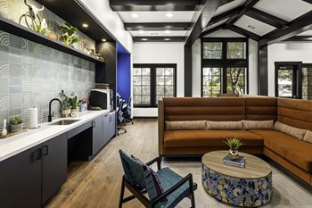 a living room with a kitchen and a couch