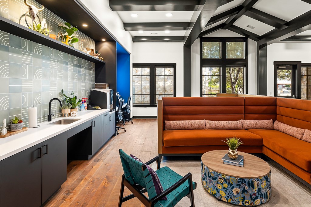 a living room with a couch and a kitchen