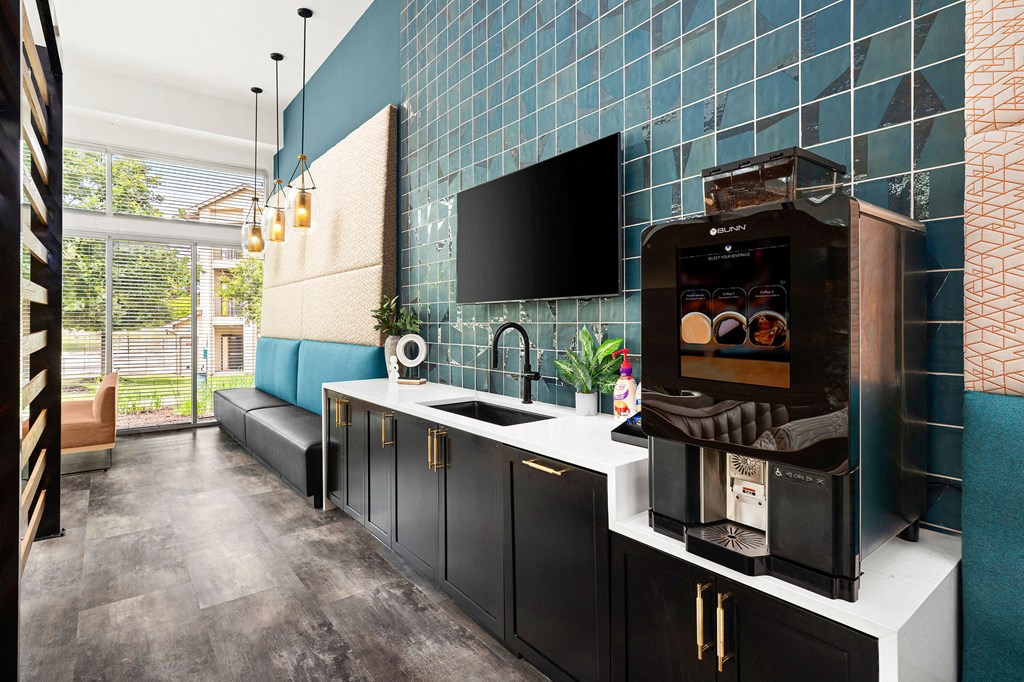 a kitchen with blue tiles and a coffee machine