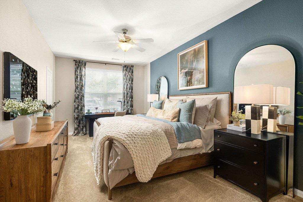 a bedroom with blue walls and a large bed
