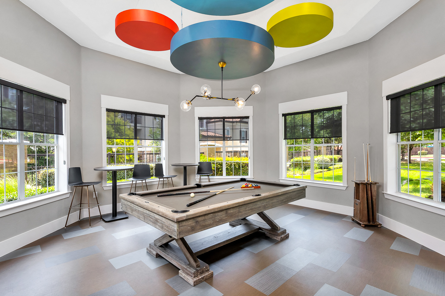 a game room with a pool table and colorful ceiling lights