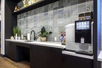a kitchen with a coffee maker and a sink