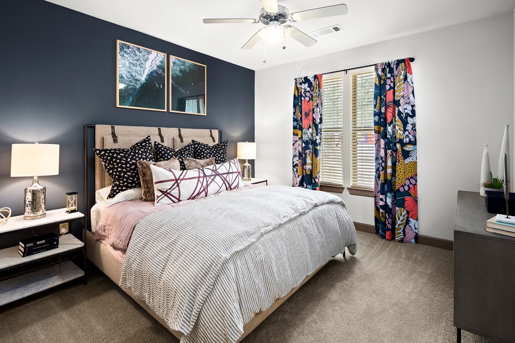 a bedroom with a bed and a ceiling fan