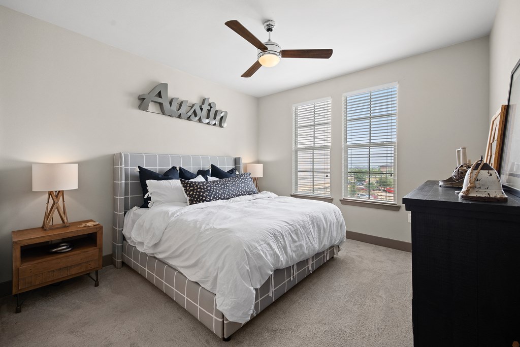 a bedroom with a bed and a ceiling fan