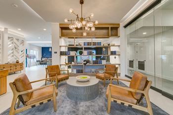 a living room filled with furniture and a chandelier