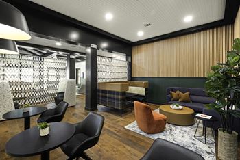 a lounge area with couches tables and chairs and a bar