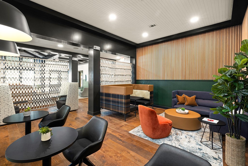 a lounge area with couches chairs and tables and a bar