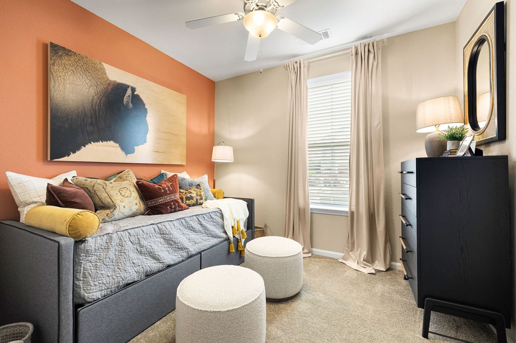 a bedroom with a bed and a ceiling fan