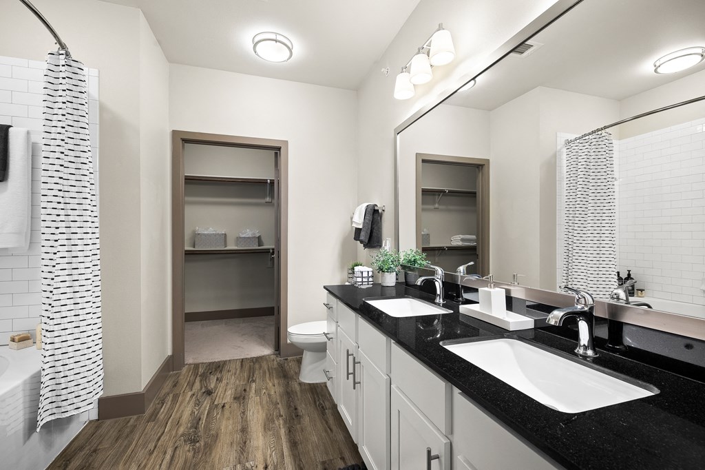 a bathroom with two sinks and a shower and a toilet