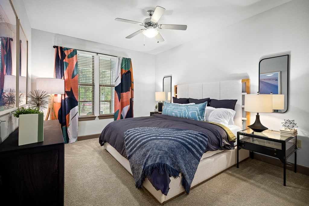 a bedroom with a bed and a ceiling fan