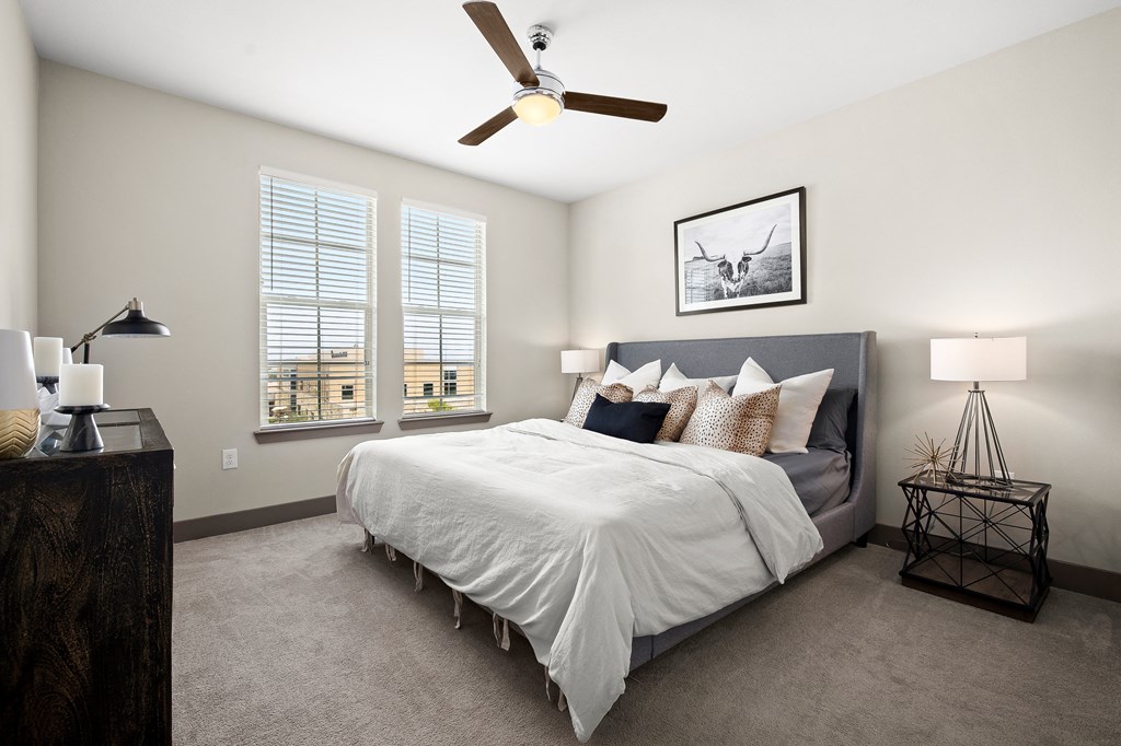 a bedroom with a bed and a ceiling fan