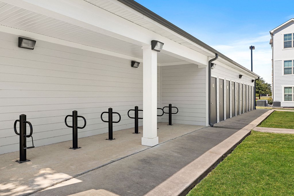 a row of garage doors at the whispering winds apartments in pearland, tx