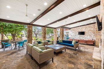 a living room with couches and chairs and a tv