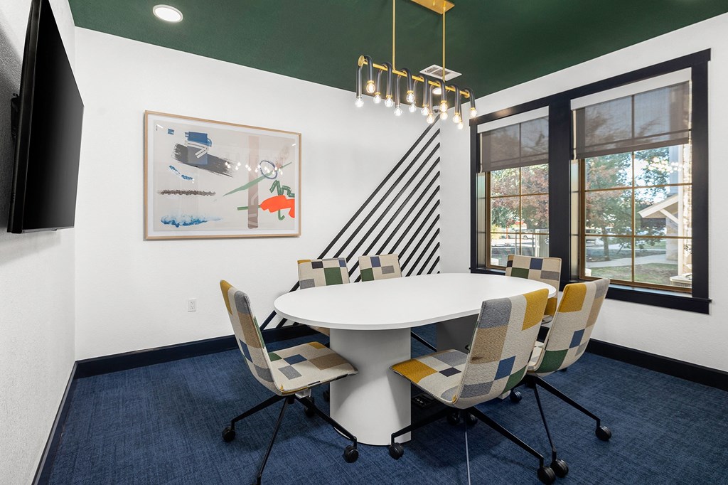 a conference room with a white table and chairs