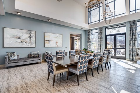 A dining room with a long table and chairs.