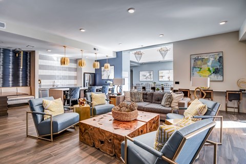 A living room with a blue chair and a wooden coffee table.