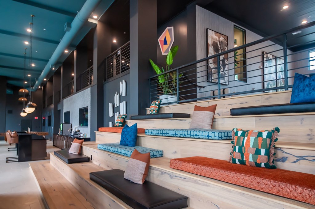 a seating area with pillows and cushions in a lobby