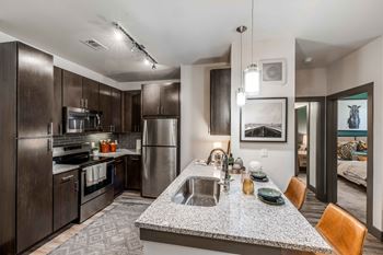 a kitchen with stainless steel appliances and granite counter tops