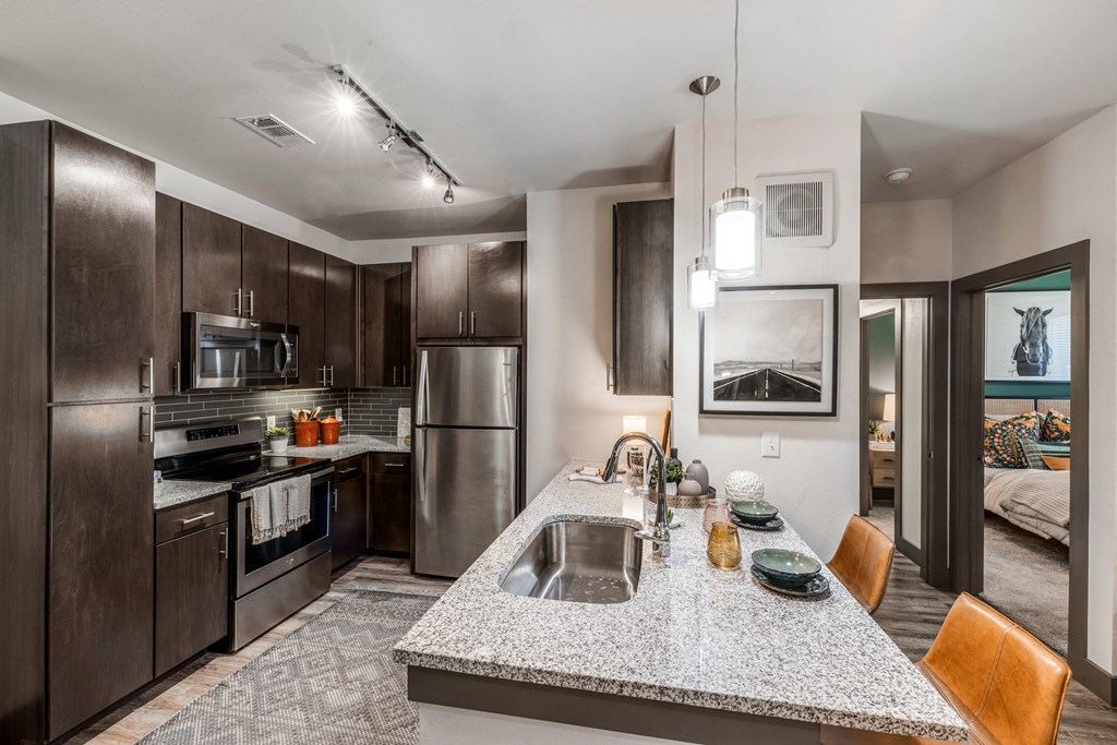 a kitchen with stainless steel appliances and granite counter tops