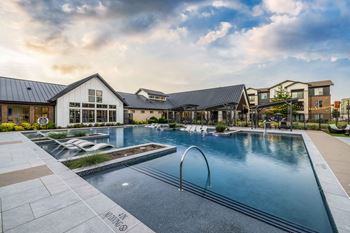 a large swimming pool with a building in the background