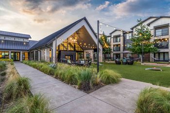 the yard of a house with a patio and a sidewalk
