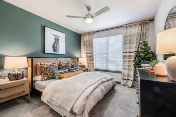 a bedroom with a bed and a ceiling fan