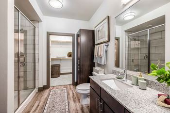 a bathroom with a shower and a sink and a toilet