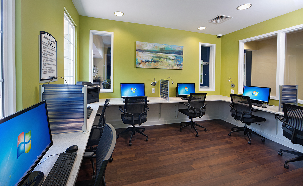 a computer room with several computers on desks and chairs