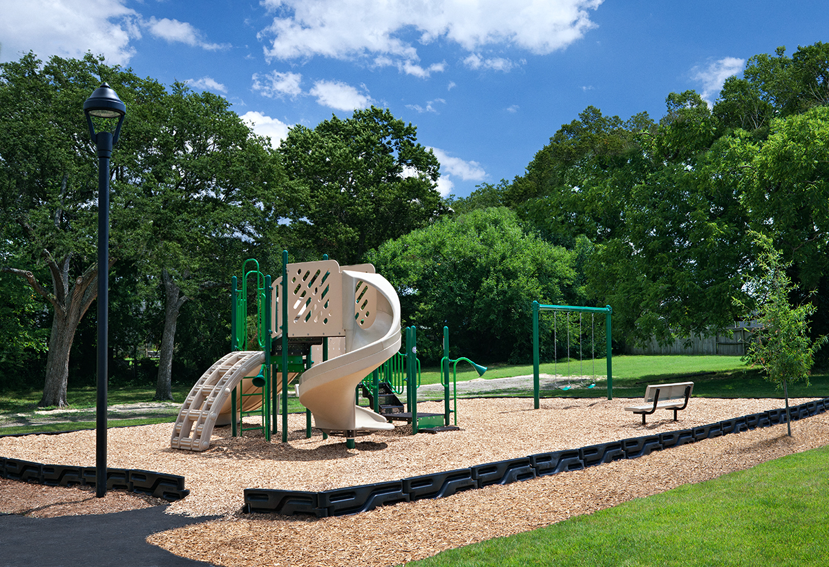a playground with a slide in a park