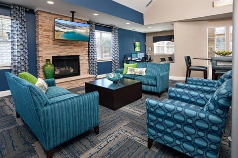 a living room with blue furniture and a fireplace