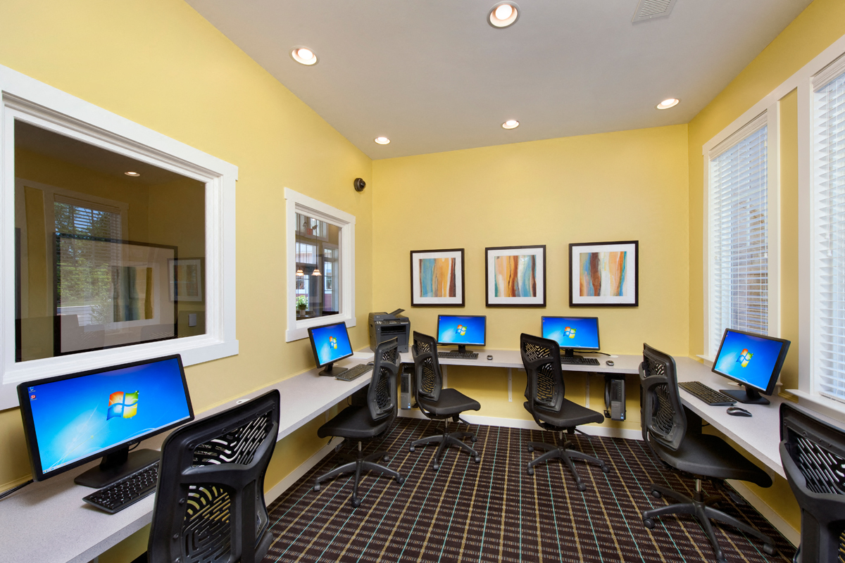 a room filled with computer desks and chairs