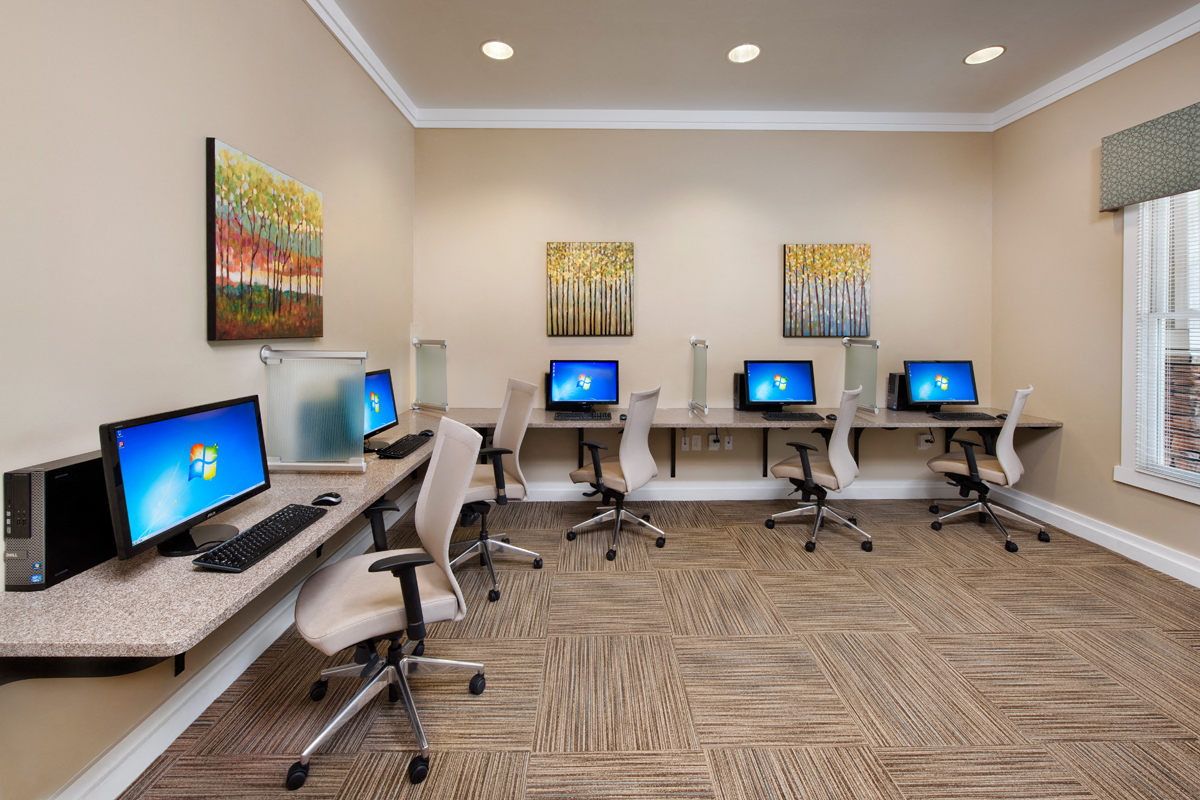 a room with a row of computers on a desk