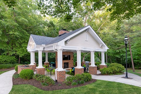 A small house with a porch and a covered patio.