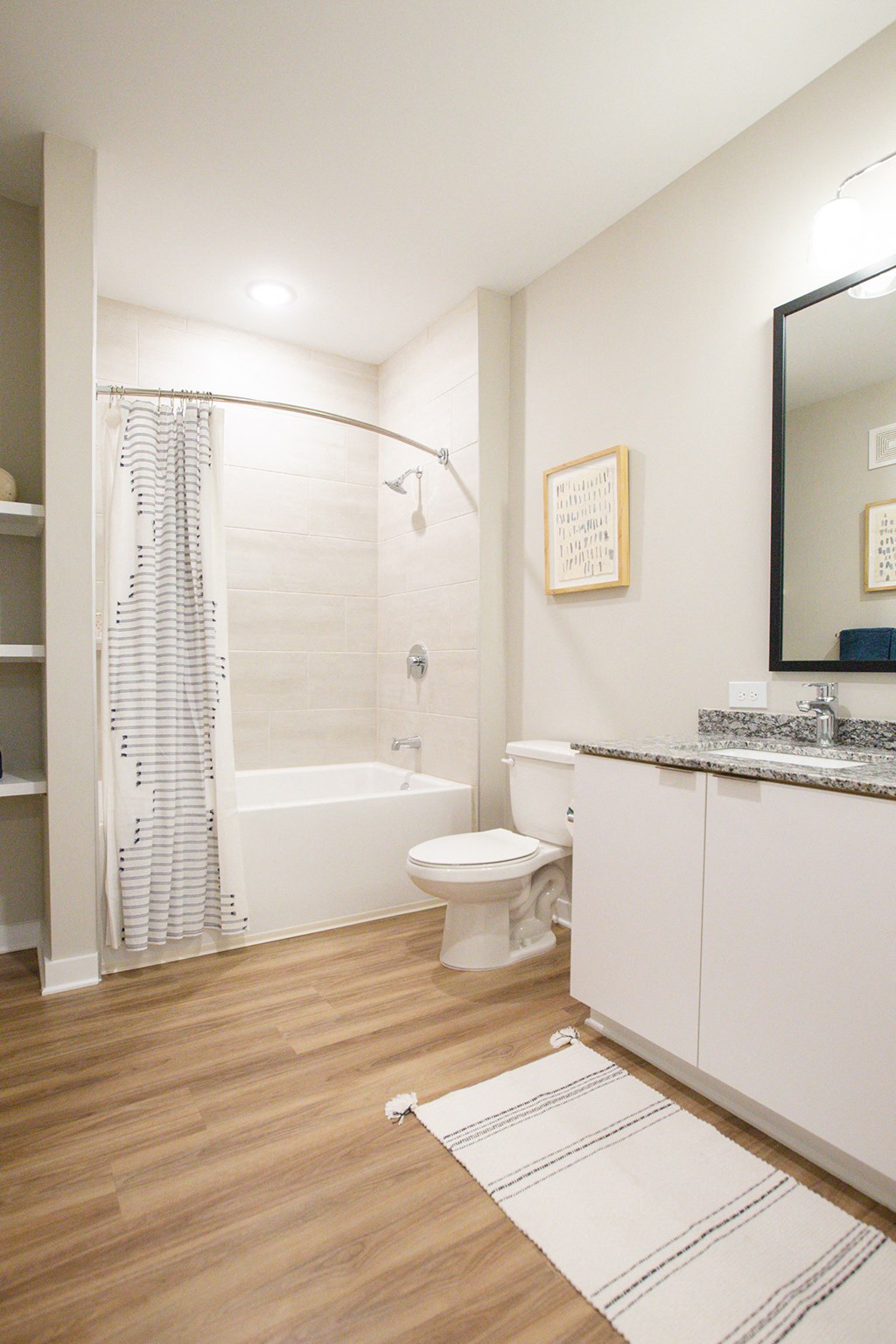 a bathroom with a shower toilet and sink and a mirror