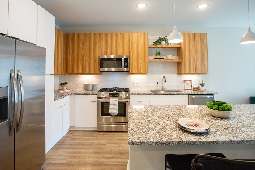 a modern kitchen with stainless steel appliances and granite counter tops