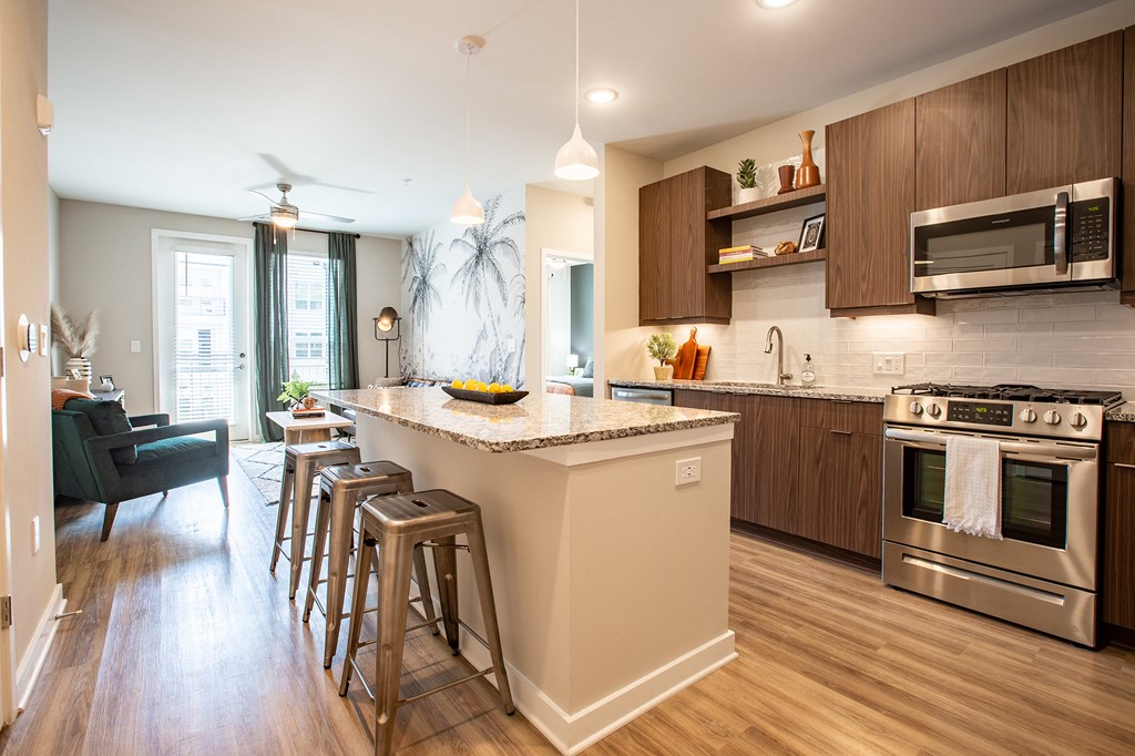 an open kitchen with a large island with bar stools