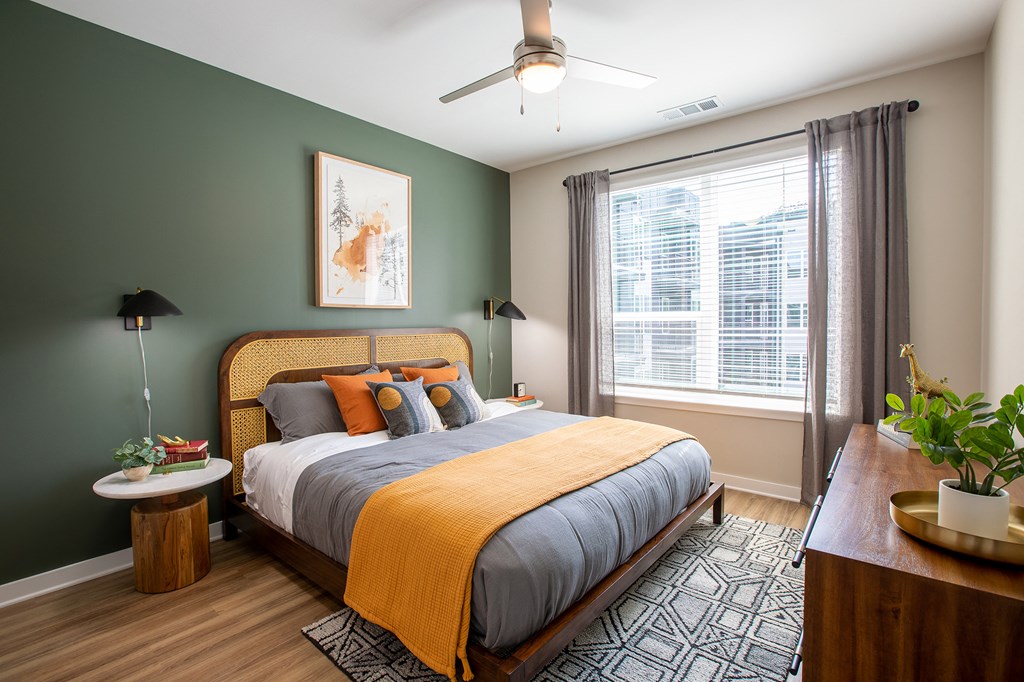 a bedroom with a bed and a ceiling fan